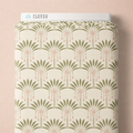 Art Deco Palms fabric styled on a bolt against a peach background